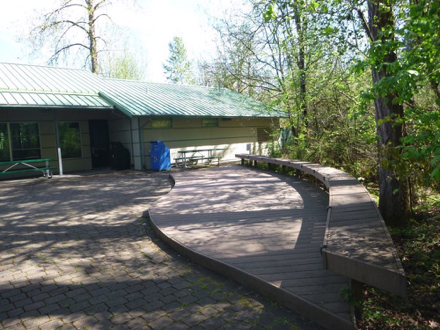 Interpretive center brick patio - picnic tables - platform with benches - garbage/recycling receptacles